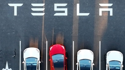 An aerial view shows cars parked at the Tesla Fremont Factory in Fremont, California, (AFP) An aerial view shows cars parked at the Tesla Fremont Factory in Fremont, California, (AFP)