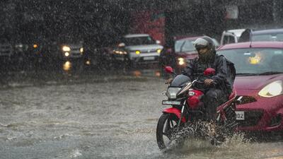 People commute through a waterlogged road amid heavy rains in New Delhi on Thursday. (PTI Photo) People commute through a waterlogged road amid heavy rains in New Delhi on Thursday. (PTI Photo)