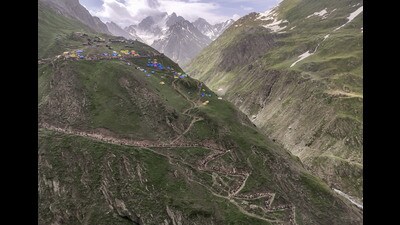 Pilgrims climb up an uhill trail to the holy cave shrine of Amarnath in Jammu & Kashmir on Thursday. (PTI)