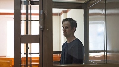 FILE PHOTO: Wall Street Journal reporter Evan Gershkovich, who was arrested in March while on a reporting trip and accused of espionage, stands behind a glass wall of an enclosure for defendants before a court hearing to consider an appeal against his detention, in Moscow, Russia June 22, 2023. REUTERS/Evgenia Novozhenina//File Photo (REUTERS)