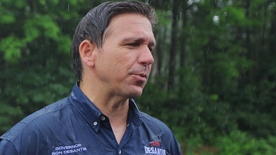 U.S. Republican presidential candidate Florida Governor Ron DeSantis talks to reporters after walking in the Fourth of July Parade in the rain in Merrimack, New Hampshire, U.S., July 4, 2023. (REUTERS)