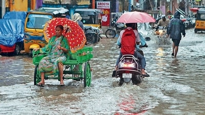 Commuters ply along the flooded street amid heavy rainfall on Monday. (ANI File) Commuters ply along the flooded street amid heavy rainfall on Monday. (ANI File)