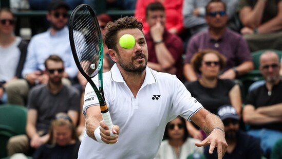 Stan Wawrinka returns the ball to Argentina's Tomas Martin Etcheverry during 2023 Wimbledon Championships (AFP)