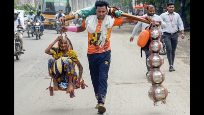 Dev and his grandmother reached the Raj Nagar Extension intersection of Delhi-Meerut Road on Friday morning and still have another 70km to cover before they reach their village Dharasu. (Sakib Ali/HT Photo) Dev and his grandmother reached the Raj Nagar Extension intersection of Delhi-Meerut Road on Friday morning and still have another 70km to cover before they reach their village Dharasu. (Sakib Ali/HT Photo)