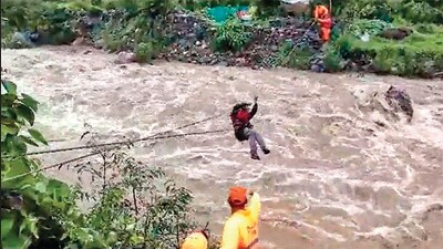NDRF personnel rescue a person trapped in Alchona village of Nainital. (PTI)