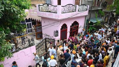 Neighbours gather around the house where three members of a family were found murdered in Salem Tabri area of Ludhiana on Friday. (Gurpreet Singh/HT) Neighbours gather around the house where three members of a family were found murdered in Salem Tabri area of Ludhiana on Friday. (Gurpreet Singh/HT)