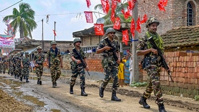 Security personnel conduct a route march ahead of the West Bengal panchayat polls, in Nadia, Friday. (PTI)