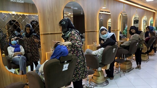 Beauticians put makeup on customers at Ms. Sadat's Beauty Salon in Kabul, Afghanistan on April 25. (AP)