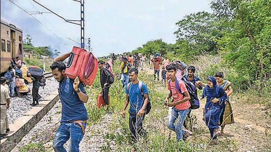 Passengers deboard the Falaknama Express train after it caught fire, in Yadadri Bhuvanagiri district, Telangana on Friday. (PTI)