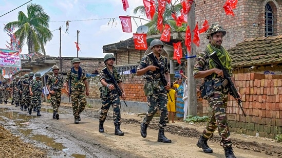Security personnel conduct a route march ahead of the West Bengal panchayat polls, in Nadia, Friday. (PTI)