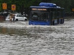 Traffic moves through a water logged street after the heavy rains in New Delhi. Traffic moves through a water logged street after the heavy rains in New Delhi.