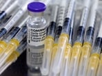 FILE PHOTO: A vial of Biontech-Pfizer's Comirnaty vaccine against COVID-19 and syringes are seen during vaccination at the Institute for Health and Food Safety of Zenica, Bosnia and Herzegovina, December 16, 2021. REUTERS/Dado Ruvic/File Photo
