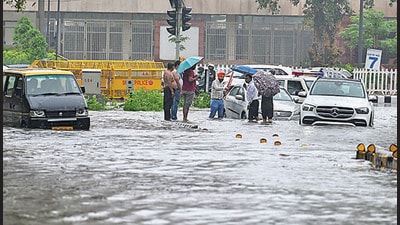 Commuters on a waterlogged street near the Supreme Court in New Delhi on Saturday. (Raj K Raj/HT Photo) Commuters on a waterlogged street near the Supreme Court in New Delhi on Saturday. (Raj K Raj/HT Photo)