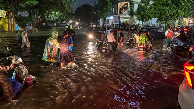 Vehicles pass through a waterlogged road after heavy monsoon rains, in Ahmedabad. (PTI) Vehicles pass through a waterlogged road after heavy monsoon rains, in Ahmedabad. (PTI)