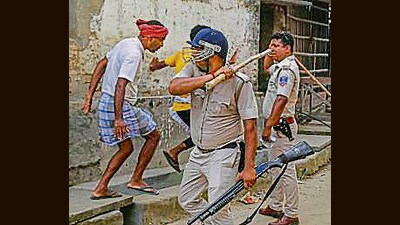 Police personnel try to disperse people during a clash between rival political groups during panchyat elections at Nagaria village in Malda, West Bengal, on Saturday. (PTI) Police personnel try to disperse people during a clash between rival political groups during panchyat elections at Nagaria village in Malda, West Bengal, on Saturday. (PTI)
