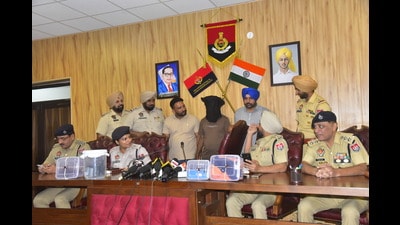 The triple murder accused (face covered) in police custody in Ludhiana on Saturday. (Gurpreet Singh/HT) The triple murder accused (face covered) in police custody in Ludhiana on Saturday. (Gurpreet Singh/HT)