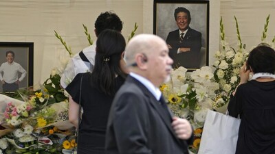 People offer prayers for Abe in Tokyo. (AP) People offer prayers for Abe in Tokyo. (AP)