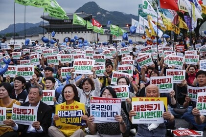 Demonstrators hold signs reading "No Dumping" and "No to the Sea, Yes in the Land" during a protest against Japan's plan to release treated wastewater from the Fukushima nuclear disaster site into the Pacific Ocean, in Seoul, South Korea, on Saturday. (Bloomberg) Demonstrators hold signs reading "No Dumping" and "No to the Sea, Yes in the Land" during a protest against Japan's plan to release treated wastewater from the Fukushima nuclear disaster site into the Pacific Ocean, in Seoul, South Korea, on Saturday. (Bloomberg)