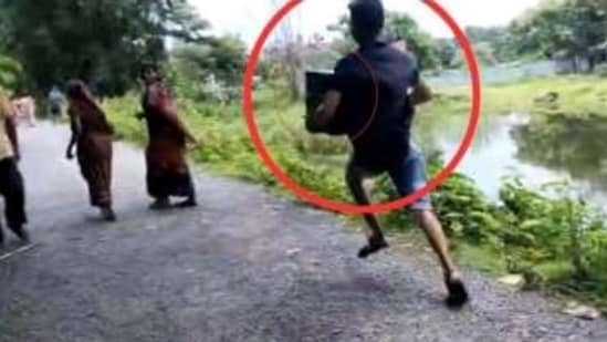 In a video, shared by the BJP, a man can be purportedly seen running with a ballot box during the West Bengal panchayat poll. (Bengal BJP Twitter)
