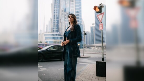 Mrunal Thakur donned a denim co-ord set which comprises an indigo wrap crop top and trousers worth <span class='webrupee'>₹</span>13,400.&nbsp;(Instagram/@mrunalthakur)