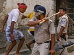 Police personnel baton charge after a clash between rival political groups during panchyat elections in Malda district of West Bengal (PTI) Police personnel baton charge after a clash between rival political groups during panchyat elections in Malda district of West Bengal (PTI)