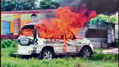 A fire blazes from a car in Uttar Dinajpur on Sunday. (ANI)
