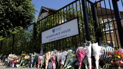 Floral tributes laid outside the school gate. (REUTERS)