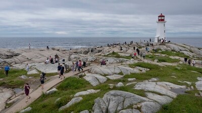 Hundreds of people walk near the lighthouse in Peggy's Cove, N.S., Tuesday, July 4, 2023. (Darren Calabrese /The Canadian Press via AP) (AP) Hundreds of people walk near the lighthouse in Peggy's Cove, N.S., Tuesday, July 4, 2023. (Darren Calabrese /The Canadian Press via AP) (AP)