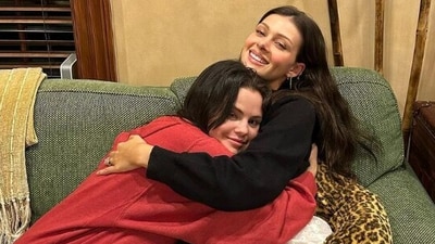 One of the photos shows Selena Gomez and Nicola Peltz Beckham hugging as they sit on a couch, with radiant smiles on their faces (selenagomez/Instagram)