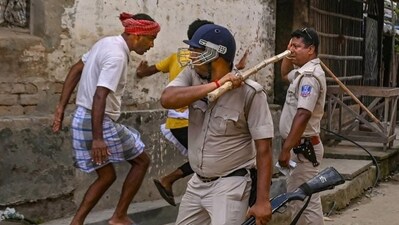 Police personnel baton charge after a clash between rival political groups during panchyat elections in Malda district of West Bengal (PTI) Police personnel baton charge after a clash between rival political groups during panchyat elections in Malda district of West Bengal (PTI)