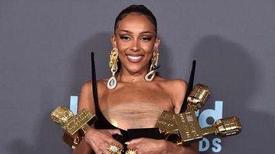 Doja Cat poses in the press room with the awards for top R&B artist, top R&B female artist, top viral song for "Kiss Me More" and top R&B album for "Planet Her" at the Billboard Music Awards. (Jordan Strauss/Invision/AP) Doja Cat poses in the press room with the awards for top R&B artist, top R&B female artist, top viral song for "Kiss Me More" and top R&B album for "Planet Her" at the Billboard Music Awards. (Jordan Strauss/Invision/AP)