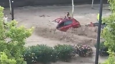 Several videos went viral on social media showing people clinging on to the roof of their cars as their vehicles are being washed away by the raging water.