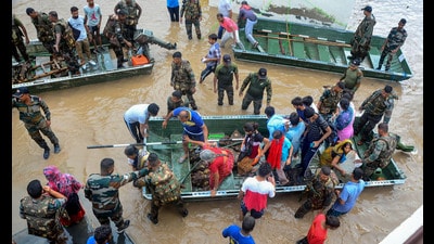 Indian Army personnel rescue people stuck in the flood-affected Sanauri Adda area after heavy monsoon rains caused rapid rise in the water level of Badi Nadi river in Patiala district. (PTI)