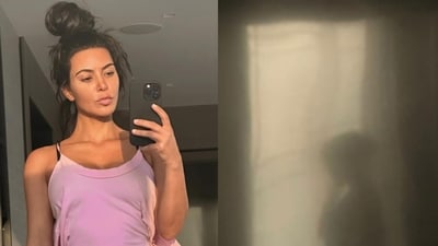 Kim Kardashian found a creepy photo while scrolling back through her phone – a selfie of herself with a strange woman at the window behind her (kimkardashian/Instagram)