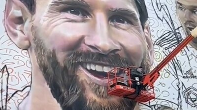 David Beckham gives finishing touches to Lionel Messi's mural. David Beckham gives finishing touches to Lionel Messi's mural.