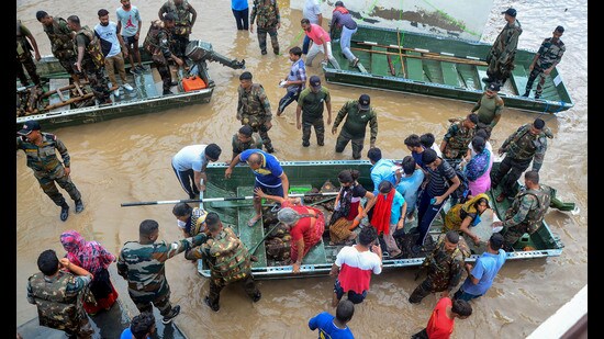 Indian Army personnel rescue people stuck in the flood-affected Sanauri Adda area after heavy monsoon rains caused rapid rise in the water level of Badi Nadi river, in Patiala district on Monday. (PTI)