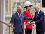 US president Joe Biden walks with Britain's King Charles III during a ceremony before their meeting at Windsor Castle.