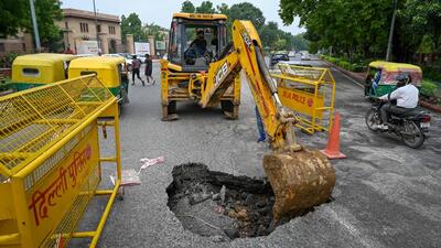 A part of the road caved-in after heavy rainfall at C Hexagon near India Gate in New Delhi on Tuesday. (Sanchit Khanna/HT Photo) A part of the road caved-in after heavy rainfall at C Hexagon near India Gate in New Delhi on Tuesday. (Sanchit Khanna/HT Photo)