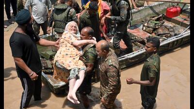 Army personnel rescue an elderly woman after water level of Badi Nadi rose due to heavy rains in Patiala on Tuesday. (ANI)