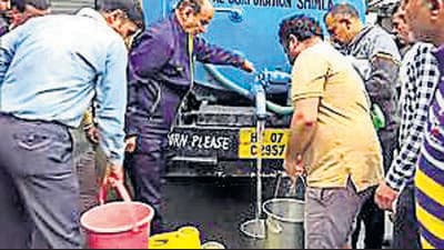 People collect water from Shimla on Tuesday. (ANI) People collect water from Shimla on Tuesday. (ANI)