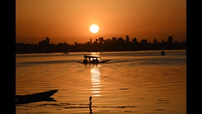 Tourists enjoy Shikara ride on the waters of Dal Lake during sunset in Srinagar on Tuesday. (Waseem Andrabi /HT)