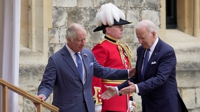 US president Joe Biden walks with Britain's King Charles III during a ceremony before their meeting at Windsor Castle. (Reuters)