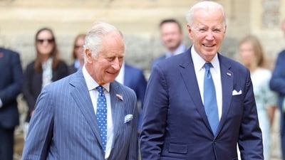 Britain's King Charles and US president Joe Biden walk together in the Quadrangle at  Windsor Castle. (Reuters)