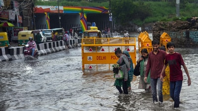 New Delhi: People wade through a waterlogged road following heavy monsoon rains near Yamuna Bazar Hanuman Mandir, in New Delhi. (PTI) New Delhi: People wade through a waterlogged road following heavy monsoon rains near Yamuna Bazar Hanuman Mandir, in New Delhi. (PTI)