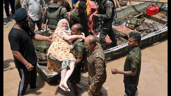 Army personnel rescue an elderly woman after water level of Badi Nadi rose due to heavy rains in Patiala on Tuesday. (ANI)
