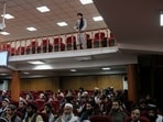 A Taliban fighter stands guard at a news conference about a new command of hijab by Taliban leader Mullah Haibatullah Akhundzada, in Kabul, Afghanistan.