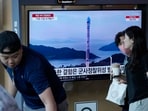 A TV screen shows a file image of North Korea's rocket launch during a news program, at the Seoul Railway Station in Seoul.