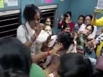 Women in Kolkata local train get into fight, beat each other with slippers. 