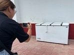 A Thai reporter takes a photo of an empty freezer at the Nong Prue police station in Pattaya, Chonburi province, A Thai reporter takes a photo of an empty freezer at the Nong Prue police station in Pattaya, Chonburi province,