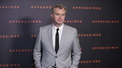 Oppenheimer director Christopher Nolan poses at the film's premiere in Paris. Oppenheimer is his first film to receive an R rating since his 2022 film Insomnia. Robert Downey Jr., Matt Damon, and Emily Blunt reportedly took pay cuts to work on the film. (AFP) Oppenheimer director Christopher Nolan poses at the film's premiere in Paris. Oppenheimer is his first film to receive an R rating since his 2022 film Insomnia. Robert Downey Jr., Matt Damon, and Emily Blunt reportedly took pay cuts to work on the film. (AFP)